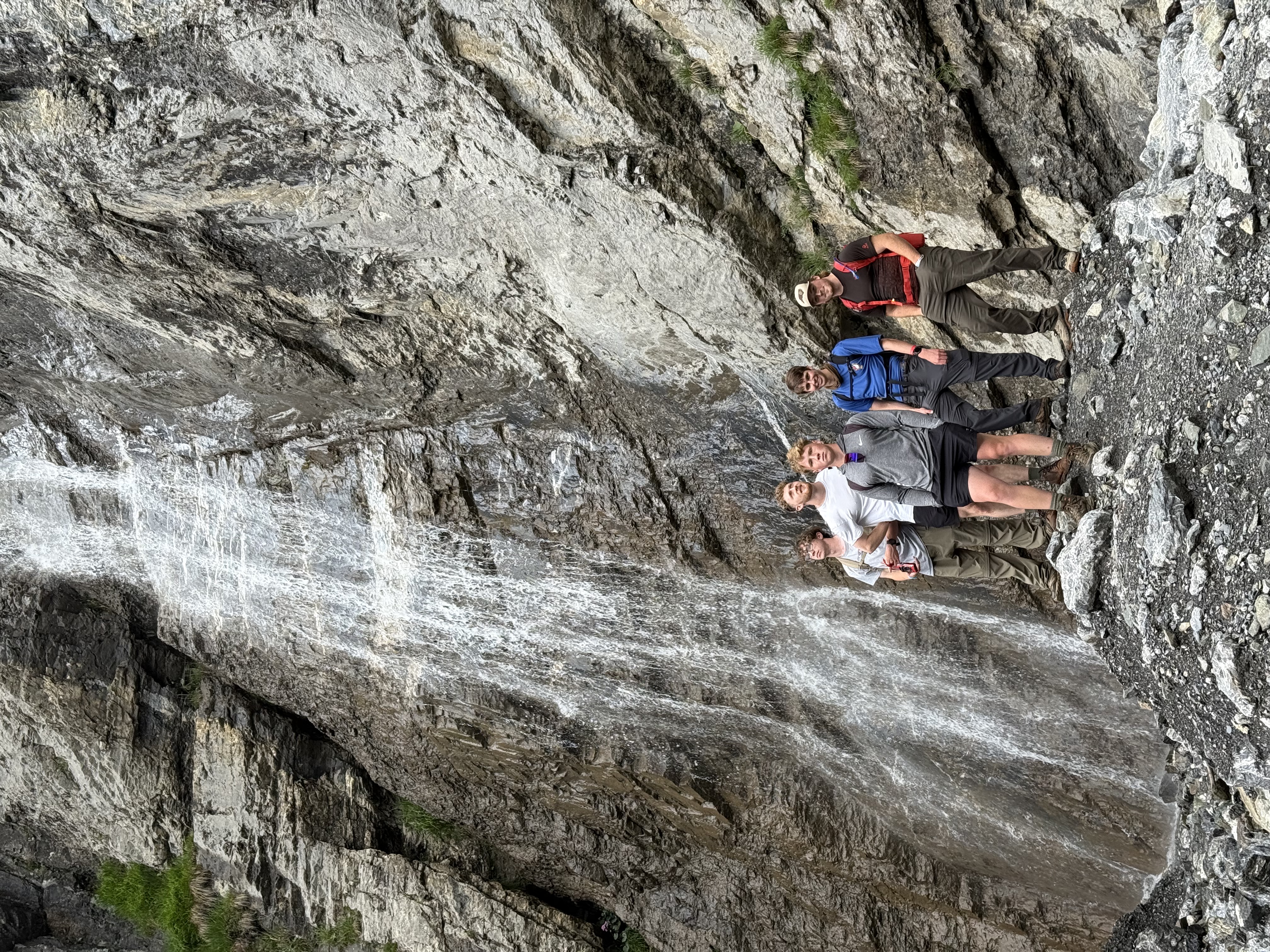 Group photo by a waterfall